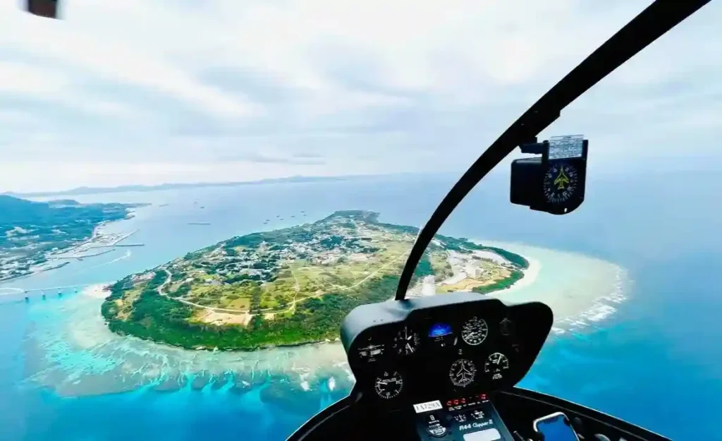 Breathtaking aerial view of Okinawa's vibrant blue ocean and lush islands from a private helicopter tour.