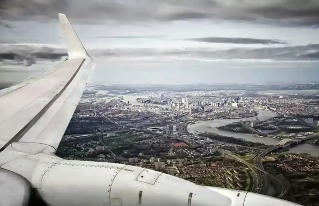 Panoramic London skyline seen from a private jet, capturing the city's vast urban landscape during takeoff or landing.